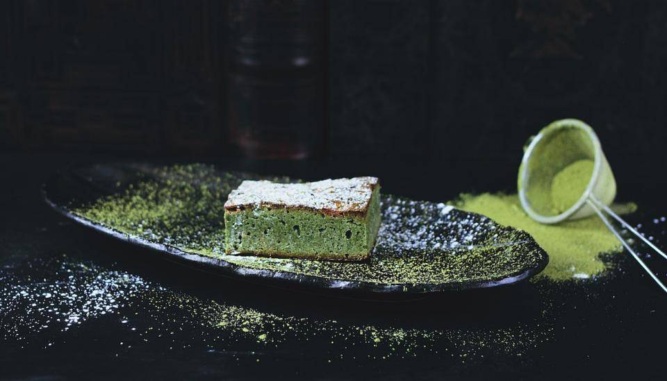 Matcha brownie dusted with powdered sugar and matcha powder