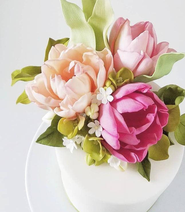 Gum paste flowers on a small white cake