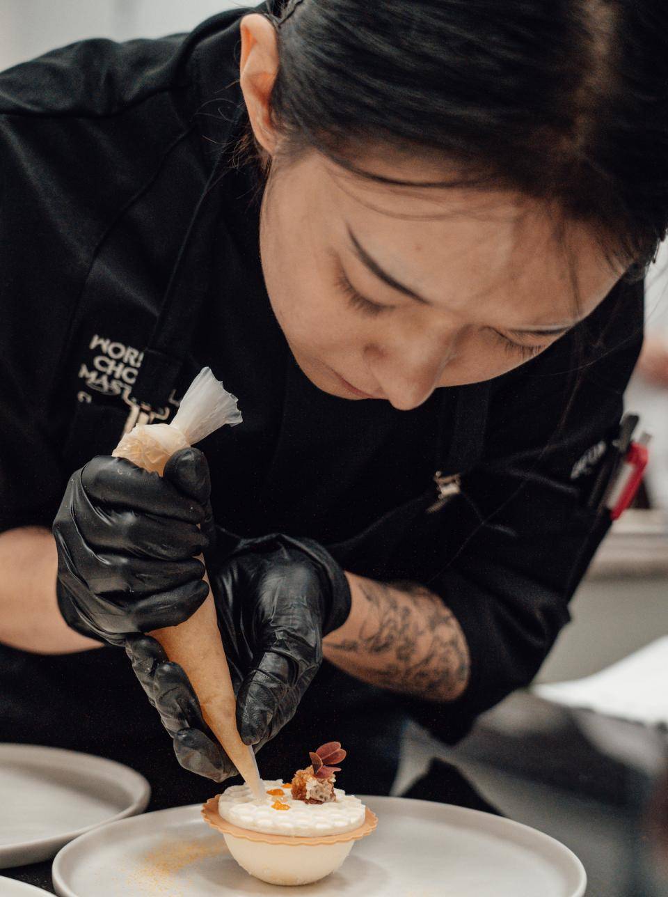 Charlotte Wang focuses on her creation at the WCM NA competition