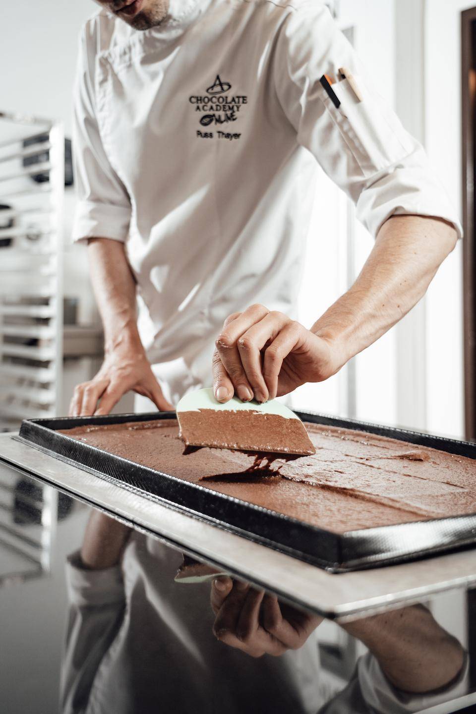 Chef Russ Thayer smooths sponge batter into a silicone frame