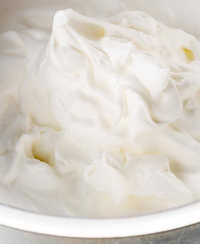 a bowl of egg whites whipped to medium peaks