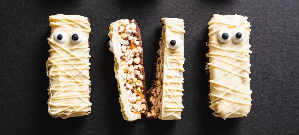 granola-type bars covered in white chocolate and decorated to look like mummies