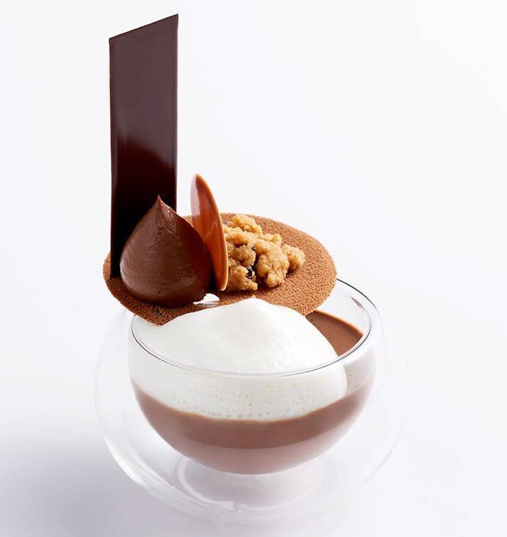 A layered chocolate dessert in a glass